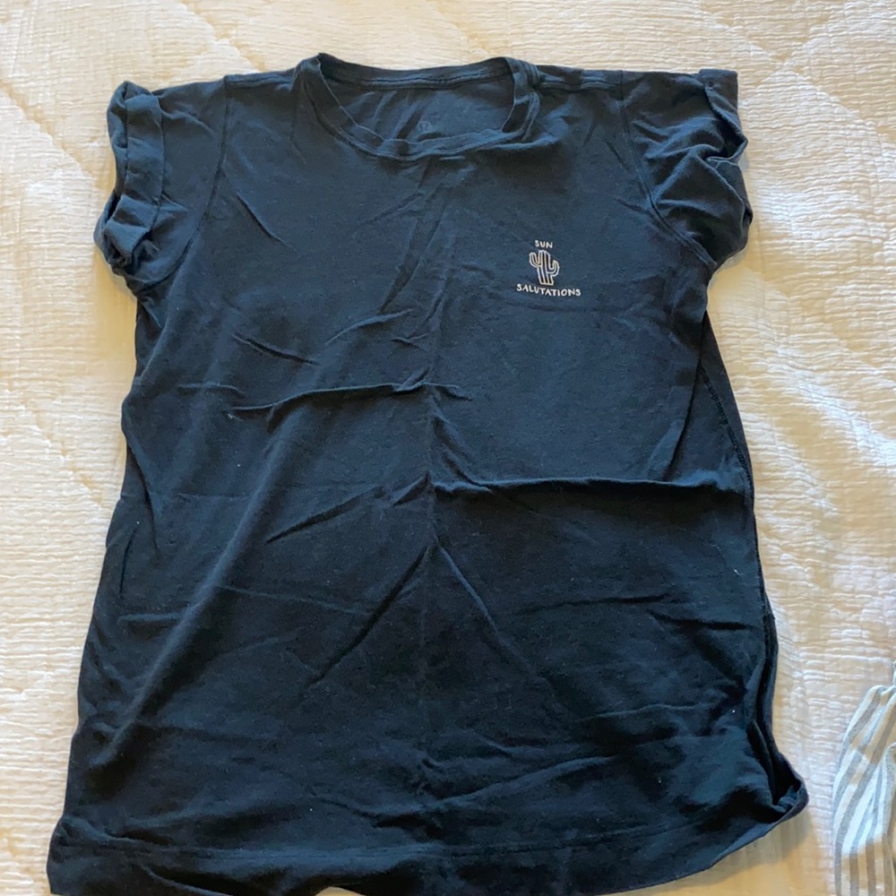 Black lululemon tee shirt with sun salutation wording on the front